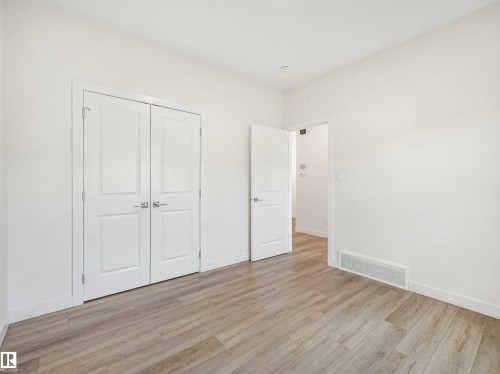 Room featuring light wood-finish flooring, white walls, white baseboards, and white trim - 1518 Siskin Link Link, Edmonton, AB - Indoor Photo Showing Other Room