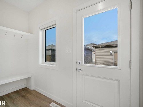 Entry area featuring a clear pane door and a single window - 1518 Siskin Link Link, Edmonton, AB - Indoor Photo Showing Other Room