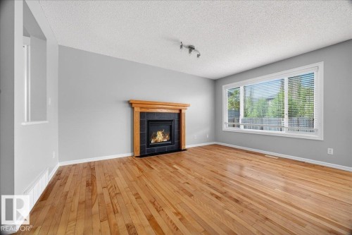 83 Becker Crescent, Fort Saskatchewan, AB - Indoor Photo Showing Living Room With Fireplace