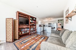 Open-concept living space featuring wood-finish flooring - 