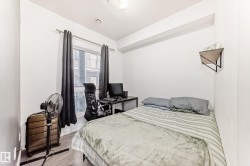 Bright bedroom featuring a single window, hard-surface flooring, and a compact wall shelf - 