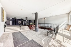Foyer featuring light-toned tile flooring, recessed lighting, and black metal railings - 