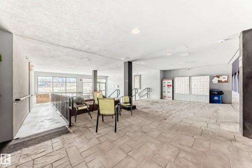 Spacious common area featuring textured concrete flooring and recessed lighting - 316 10518 113 Street, Edmonton, AB - Indoor Photo Showing Other Room