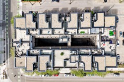 Rooftop complex featuring multiple units with individual patios, a central courtyard, and an integrated swimming pool - 