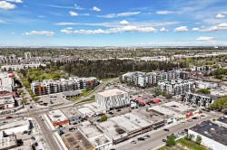 Urban landscape featuring diverse architectural styles, abundant green spaces, and established roadways - 