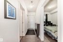 Entryway featuring wood-finish flooring, white paneled doors, and ceiling-mounted light fixtures - 316 10518 113 Street, Edmonton, AB  - Indoor Photo Showing Other Room 