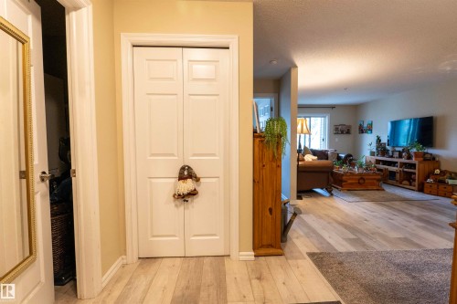 Light wood-finish flooring extending into the main living area - 203 4403 23 Street, Edmonton, AB - Indoor
