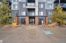 Contemporary facade featuring varied siding panels, private balconies, and a prominent main entrance - 128 390 Windermere Road, Edmonton, AB  - Outdoor With Facade 