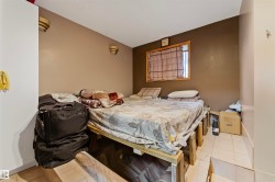 Room featuring a window with a wood frame, light tan wall, and recessed wall sconces - 