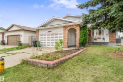 Front exterior featuring a brick archway entrance, bay window, and attached garage - 