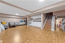 Open-concept basement with wood-finish flooring - 