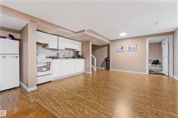 Open-concept living area with wood-finish flooring - 