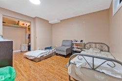 Spacious room featuring wood-finish flooring, recessed open shelving, and a cased opening - 