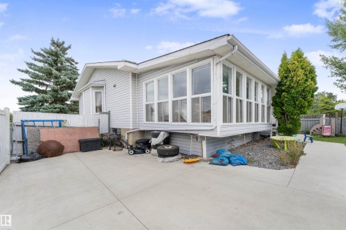Light gray siding exterior featuring a multi-pane sunroom addition and a bay window - 4231 32 Avenue, Edmonton, AB - Outdoor