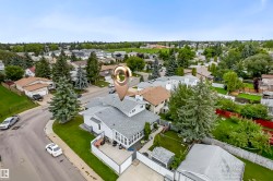 Corner lot residence featuring a sunroom addition and a fenced backyard - 