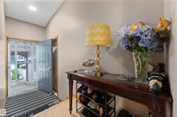 Entryway featuring a paneled door, a screen door, and a recessed ceiling light - 