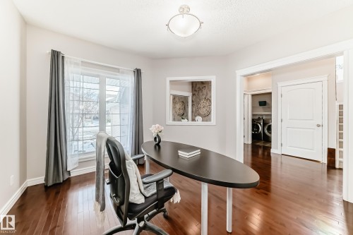 Hardwood-style flooring throughout this bright room with a large window - 1330 114B Street, Edmonton, AB - Indoor Photo Showing Office
