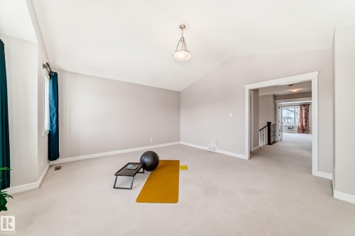 Spacious room featuring vaulted ceilings, light-colored carpeting, and neutral wall tones - 1330 114B Street, Edmonton, AB - Indoor Photo Showing Other Room