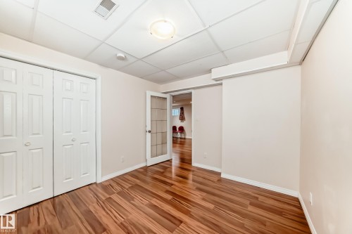 Interior space featuring wood-finish flooring, white baseboards, and neutral wall paint - 1330 114B Street, Edmonton, AB - Indoor Photo Showing Other Room