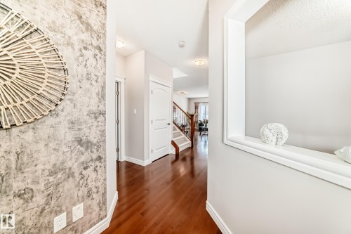 Foyer featuring wood-finish flooring, a decorative wall finish, and a built-in display niche - 1330 114B Street, Edmonton, AB - Indoor Photo Showing Other Room