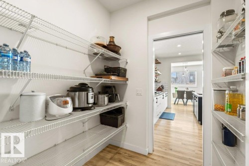 Spacious pantry featuring extensive wire shelving and light wood-finish flooring - 21003 131 Avenue, Edmonton, AB 