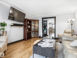 Living area featuring light wood-finish flooring and light gray walls - 