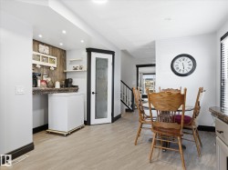 Dedicated beverage station with wood-finish accent wall and recessed lighting - 