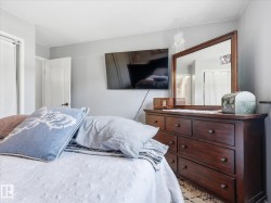 Bedroom featuring light gray walls, white baseboards, and a white ceiling - 