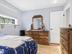 Light wood-finish flooring with a white trim window and a decorative granite shelf - 