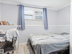 Room featuring light gray walls, white baseboards, and wood-finish flooring - 