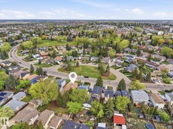 Aerial perspective of a residential area with varied housing styles and mature landscaping - 