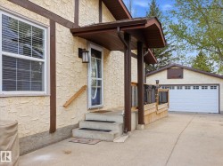 Stucco exterior with timber accents, covered entry, concrete steps, and an attached wood-decked patio - 