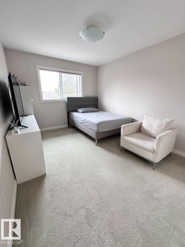 Room featuring light-colored wall paint and textured carpeting - 820 Drysdale Run, Edmonton, AB - Indoor Photo Showing Bedroom