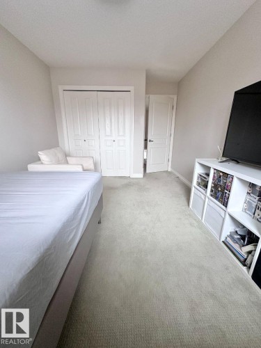 Neutral-toned carpet flooring throughout - 820 Drysdale Run, Edmonton, AB - Indoor Photo Showing Bedroom