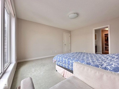 Wall-to-wall carpeting and neutral wall tones - 820 Drysdale Run, Edmonton, AB - Indoor Photo Showing Bedroom