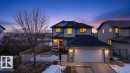 The property features a two-story exterior with a front porch, an attached garage, and a fenced yard - 16107 92 Street, Edmonton, AB  - Outdoor 