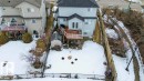 Rear exterior view of the property, featuring a raised deck with white railings and French doors - 16107 92 Street, Edmonton, AB  - Outdoor With Deck Patio Veranda 