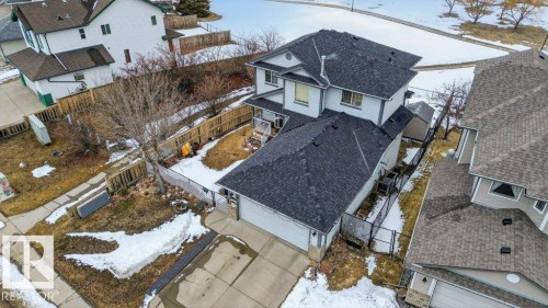Overhead view of the property, showcasing the dark shingle roof, attached garage, and fenced backyard - 16107 92 Street, Edmonton, AB - Outdoor