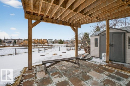 The property features a stone patio area with a wooden overhead structure - 16107 92 Street, Edmonton, AB - Outdoor With Deck Patio Veranda