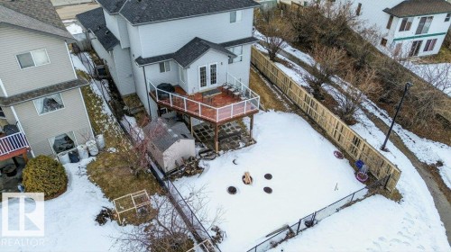 The property features a large deck with glass railings, providing an elevated outdoor living space - 16107 92 Street, Edmonton, AB - Outdoor With Deck Patio Veranda