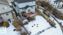 The property features a large deck with glass railings, providing an elevated outdoor living space - 16107 92 Street, Edmonton, AB  - Outdoor With Deck Patio Veranda 