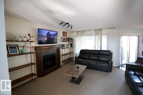 98 Walters Place, Leduc, AB - Indoor Photo Showing Living Room With Fireplace