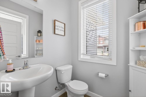 Main Floor 2 Piece Bathroom featuring Pedestal Sink and Ample Space to Add in Stylish Storage! - 20023 17A Avenue, Edmonton, AB - Indoor Photo Showing Bathroom