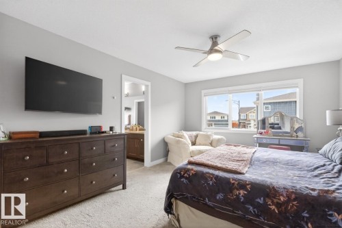 Primary Bedroom with Large South East Facing Windows, Blackout Blinds, and Enough Space to Fit a King Size Bed, Multiples Dressers, and Comfortable Lounging Corner. This bedroom is Huge! - 20023 17A Avenue, Edmonton, AB - Indoor Photo Showing Bedroom