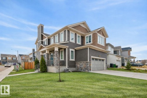 Exterior Front of Home featuring Double Garage, Corner Lot facing North West.  Extra Windows Throughout. - 20023 17A Avenue, Edmonton, AB - Outdoor With Facade