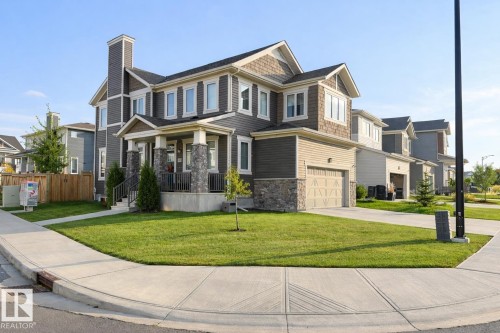 Exterior Front of Home featuring Double Garage, Corner Lot facing North West.  Extra Windows Throughout. - 20023 17A Avenue, Edmonton, AB - Outdoor With Facade