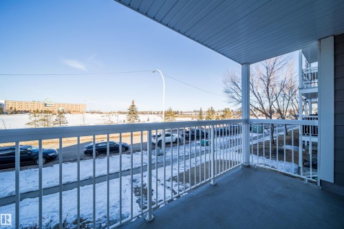 Private balcony with a concrete surface, white metal railings, and a white ceiling - 213 5065 31 Avenue, Edmonton, AB - Outdoor With Exterior