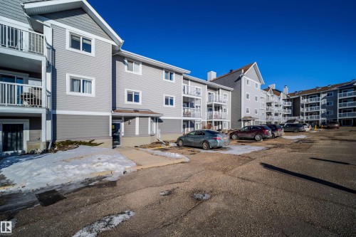 Multi-story residential building featuring light grey siding and white trim - 213 5065 31 Avenue, Edmonton, AB - Outdoor