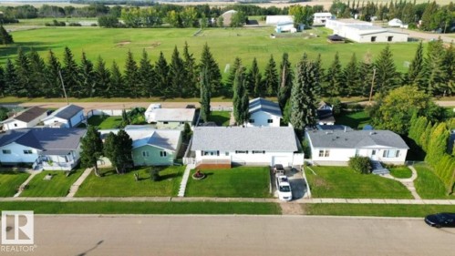 Single-story residence featuring a white exterior with a dark shingle roof - 4805 53Ave, Willingdon, AB - Outdoor With View