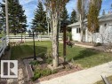 White picket fence enclosing a grassy yard - 4805 53Ave, Willingdon, AB  - Outdoor 